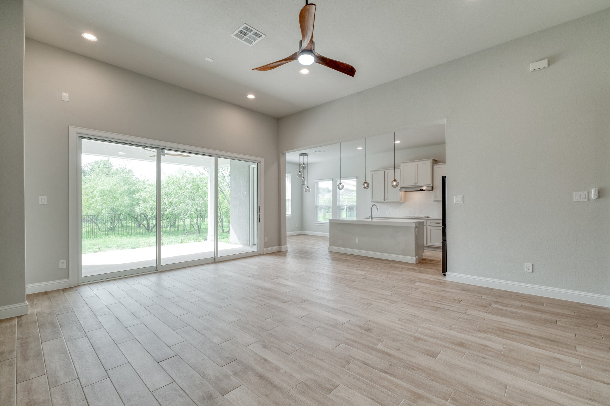 359 Raptor Beak Way Cedar Creek, TX 78612 - Photo 6 of 29 A wall of stackable sliding doors brings the Texas sky right into your living room, keeping the home feeling connected to the outdoors