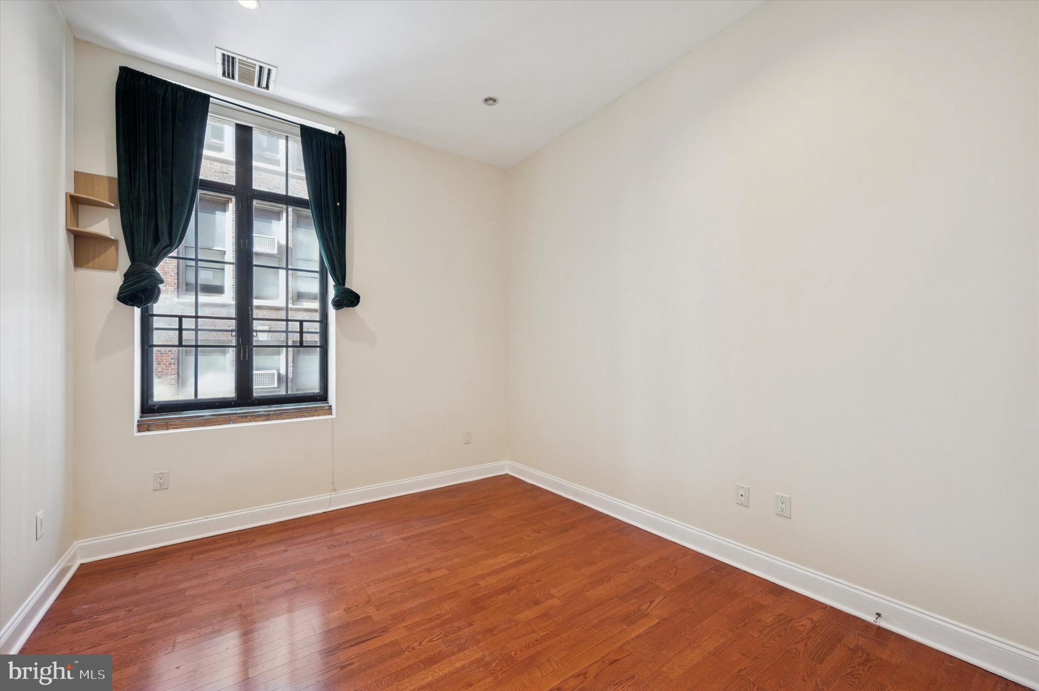 1601 Spring Garden Street, Unit 205 Philadelphia, PA 19130 - Photo 12 of 17 an empty room with windows