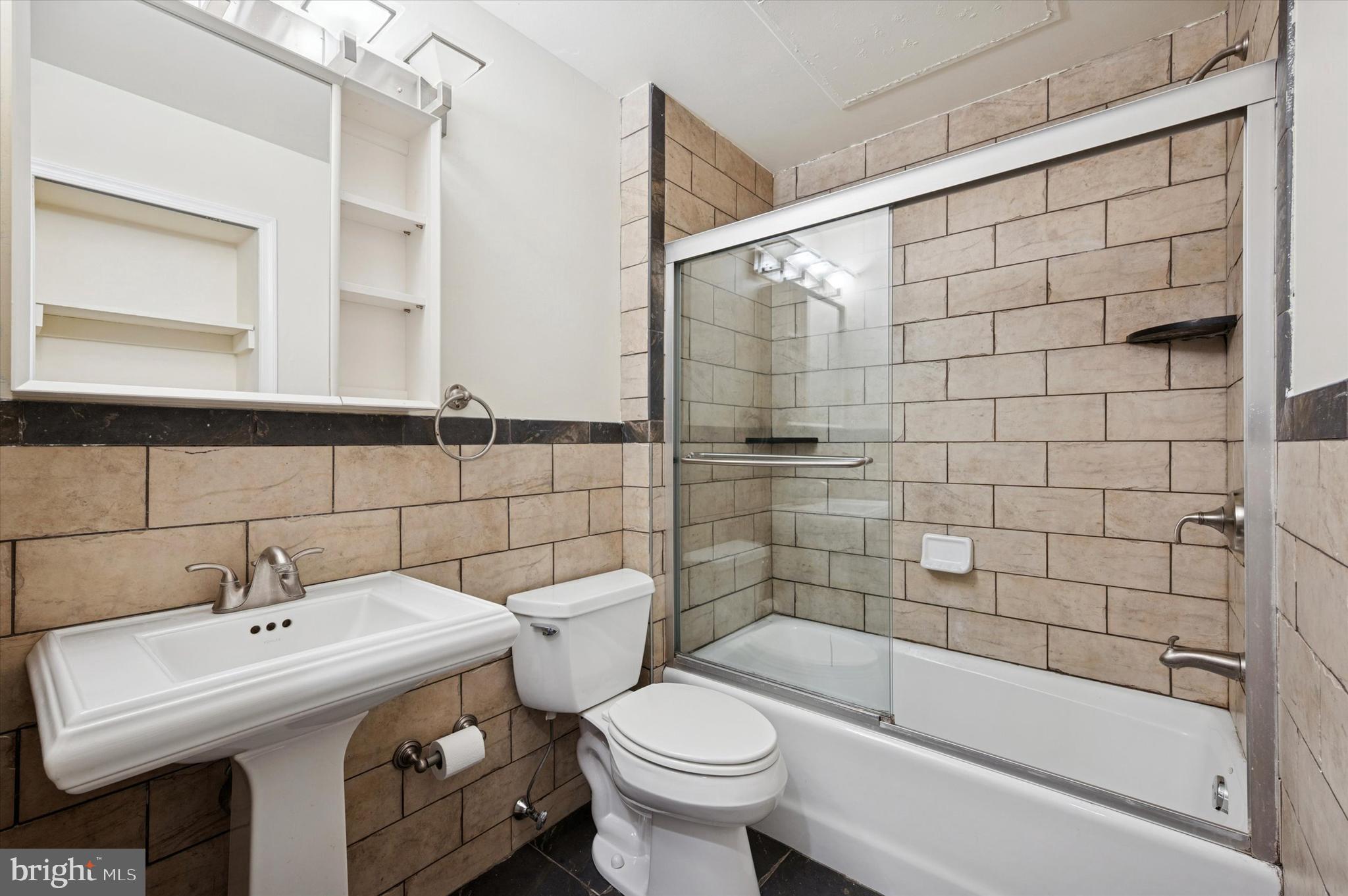 1601 Spring Garden Street, Unit 205 Philadelphia, PA 19130 - Photo 15 of 17 a bathroom with a sink toilet and shower