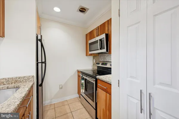 a kitchen with stainless steel appliances granite countertop a stove and a refrigerator