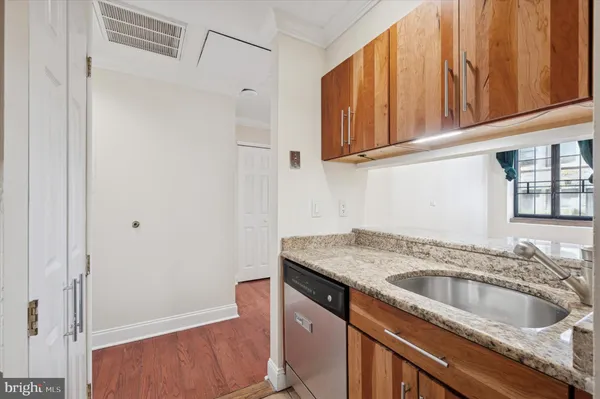 a kitchen with stainless steel appliances granite countertop a sink and a refrigerator