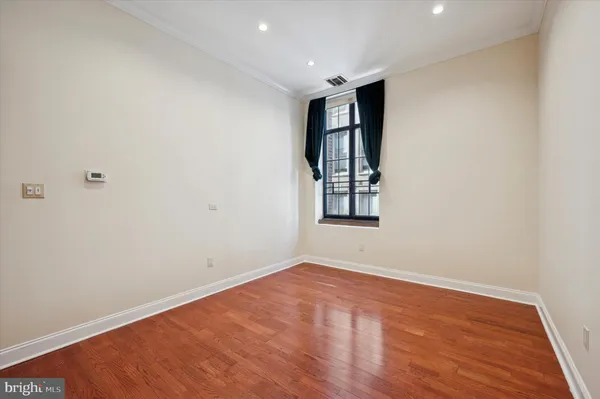an empty room with windows and closet
