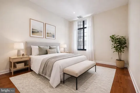 a bedroom with a bed and a night stand