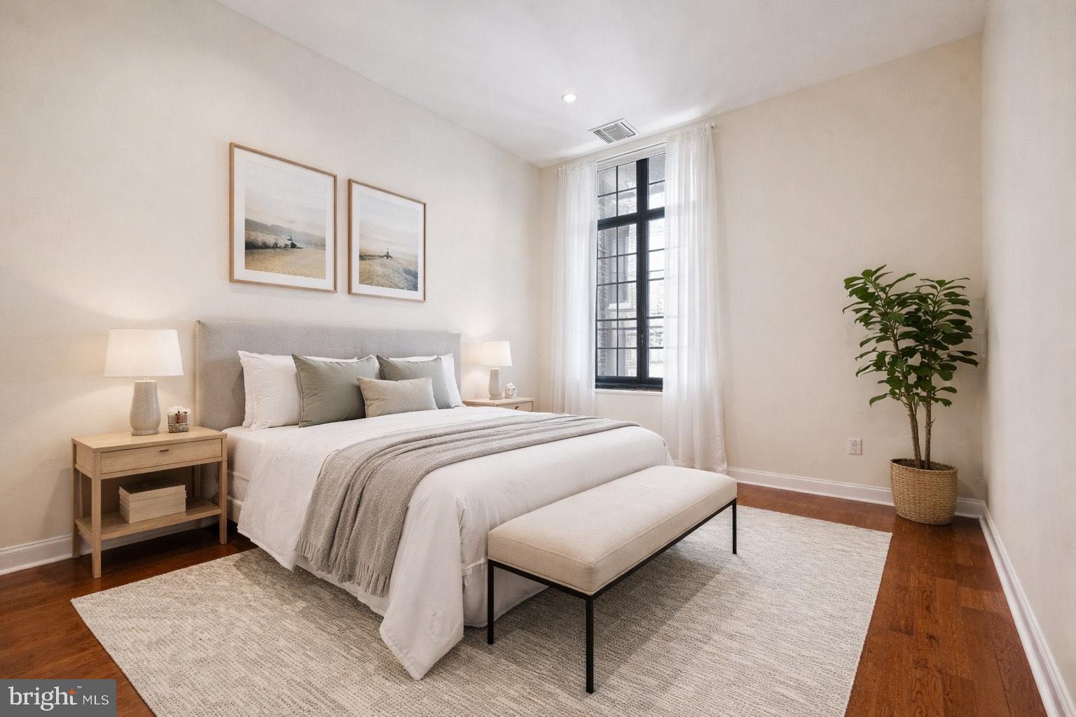 1601 Spring Garden Street, Unit 205 Philadelphia, PA 19130 - Photo 10 of 17 a bedroom with a bed and a night stand