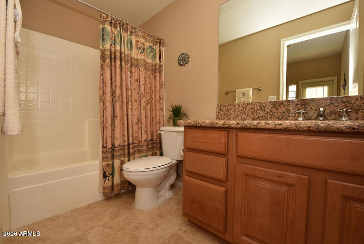 7641 East Indian Bend Road Scottsdale, AZ 85250 - Photo 14 of 19 a bathroom with a granite countertop toilet a sink and a mirror