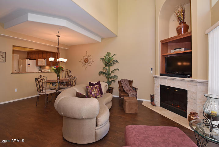 7641 East Indian Bend Road Scottsdale, AZ 85250 - Photo 6 of 19 a living room with furniture a flat screen tv and kitchen view