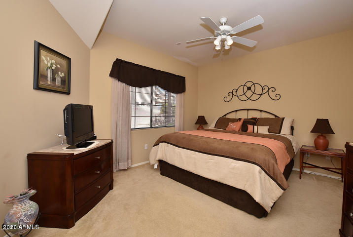7641 East Indian Bend Road Scottsdale, AZ 85250 - Photo 7 of 19 a bedroom with a bed and a tv