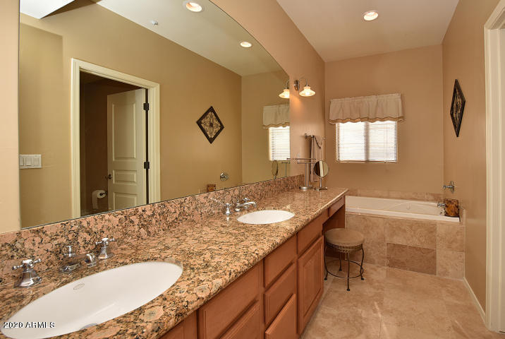7641 East Indian Bend Road Scottsdale, AZ 85250 - Photo 8 of 19 a bathroom with a granite countertop sink a toilet a mirror and shower