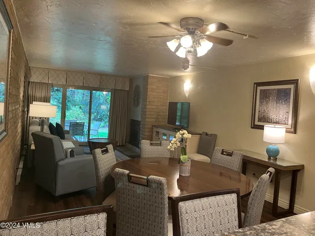 a view of a dining room with furniture and a chandelier