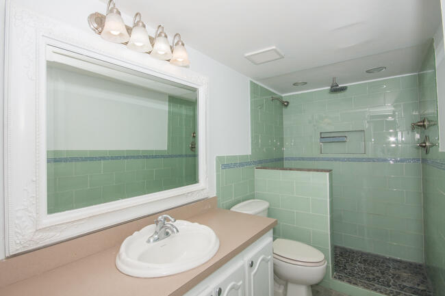 301 Croton Avenue, Unit 201 Lantana, FL 33462 - Photo 12 of 16 a bathroom with a sink a toilet and shower