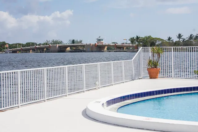 a view of a lake with a big yard and large trees