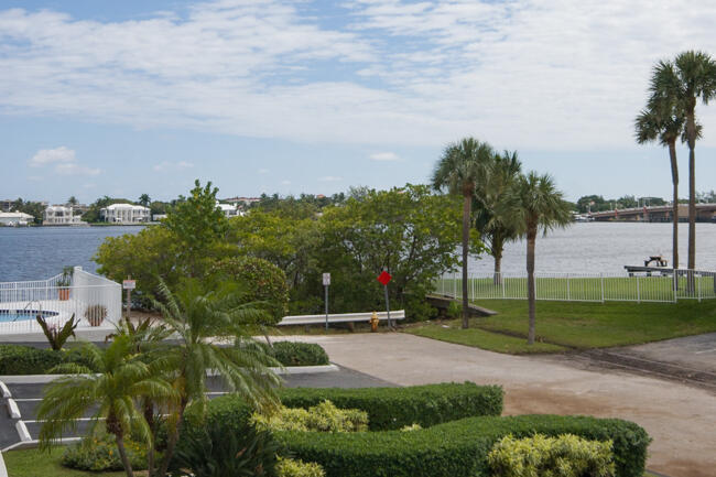 301 Croton Avenue, Unit 201 Lantana, FL 33462 - Photo 2 of 16 a view of a garden with palm trees