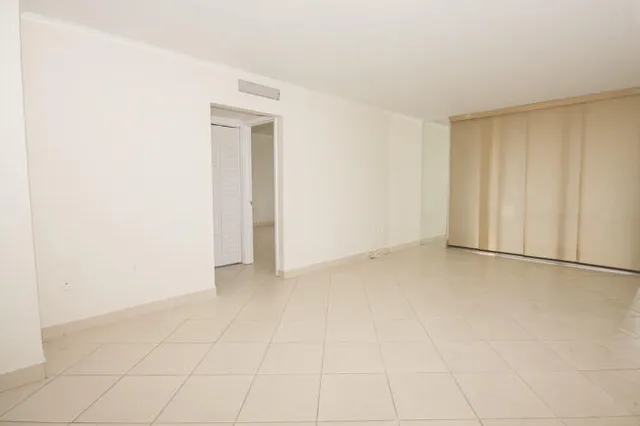 a view of an empty room and a window