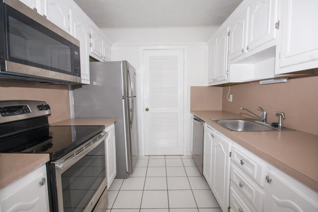 301 Croton Avenue, Unit 201 Lantana, FL 33462 - Photo 7 of 16 a kitchen with stainless steel appliances granite countertop a sink stove and refrigerator