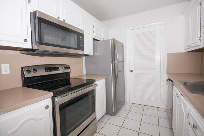 301 Croton Avenue, Unit 201 Lantana, FL 33462 - Photo 8 of 16 a kitchen with a stove microwave and refrigerator