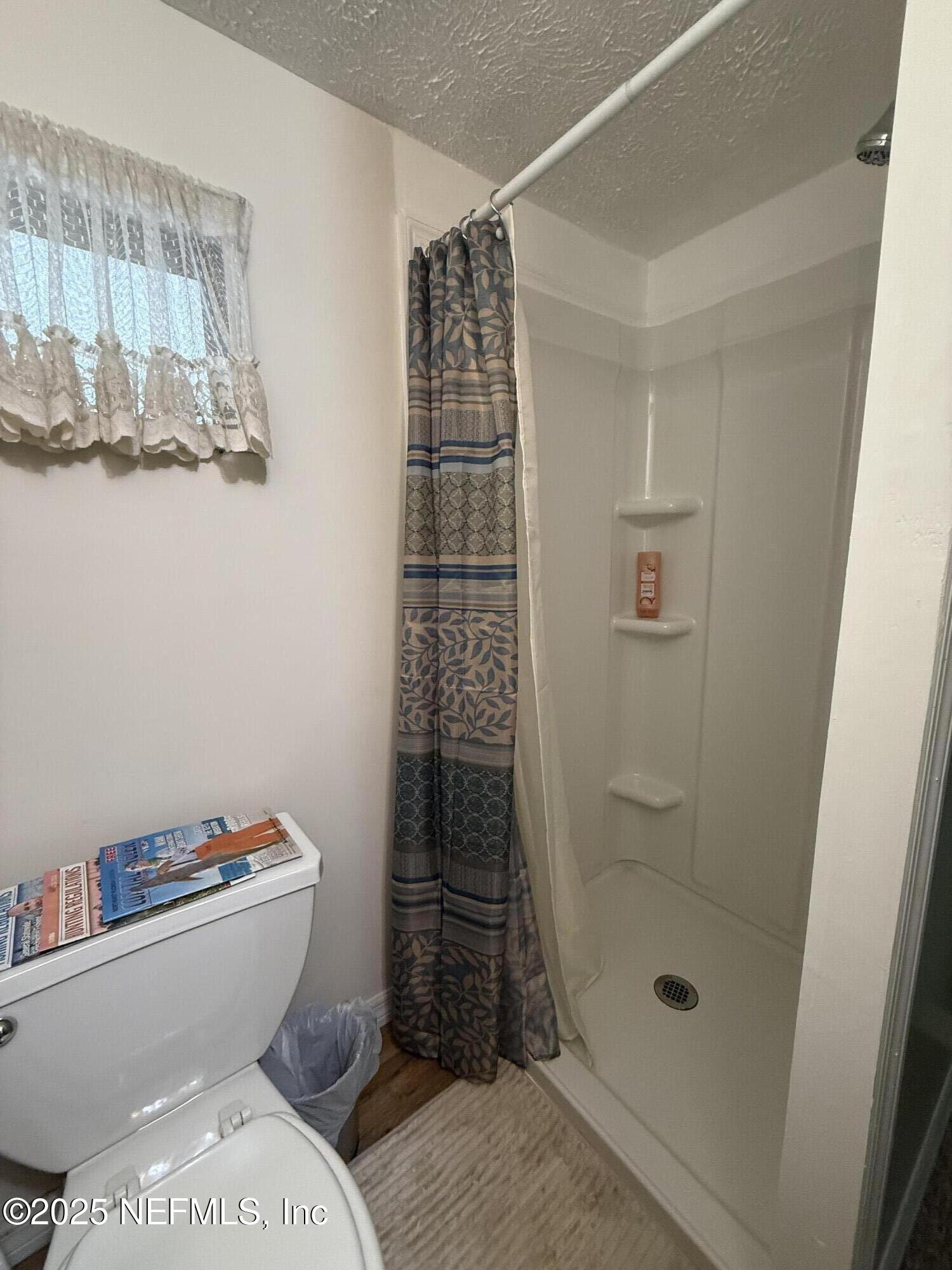 118 Riverside Avenue Satsuma, FL 32189 - Photo 18 of 27 a bathroom with a toilet and shower