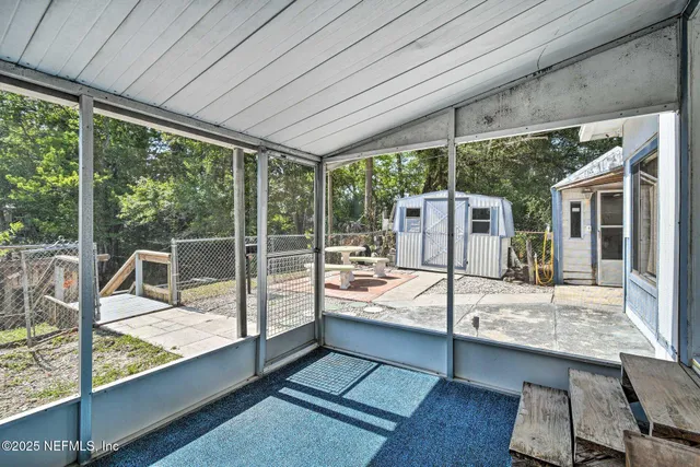 a view of a patio with a dining table and chairs