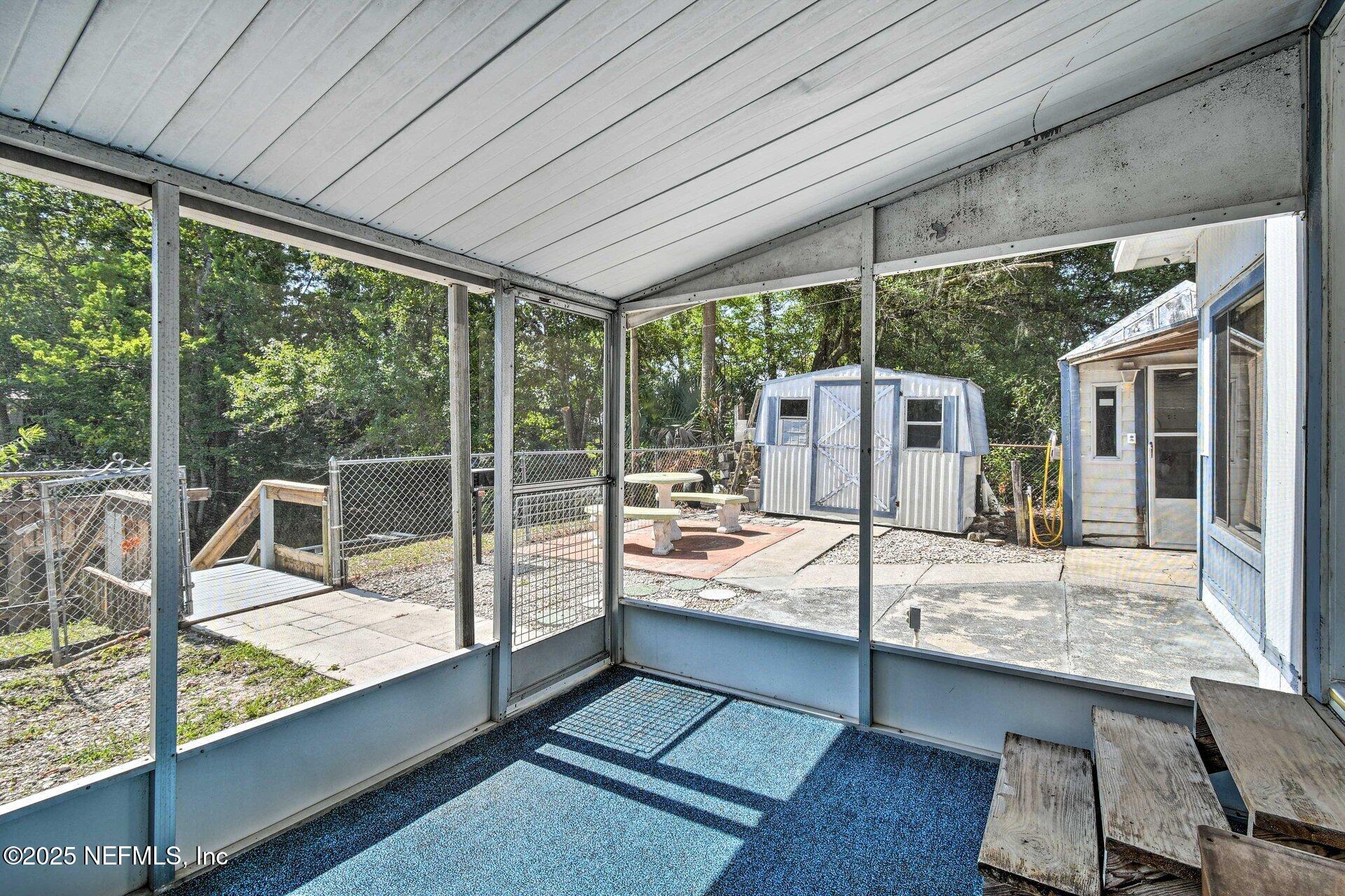 118 Riverside Avenue Satsuma, FL 32189 - Photo 19 of 27 a view of a patio with a dining table and chairs