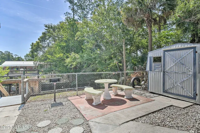 a view of a patio with a dining table and chairs