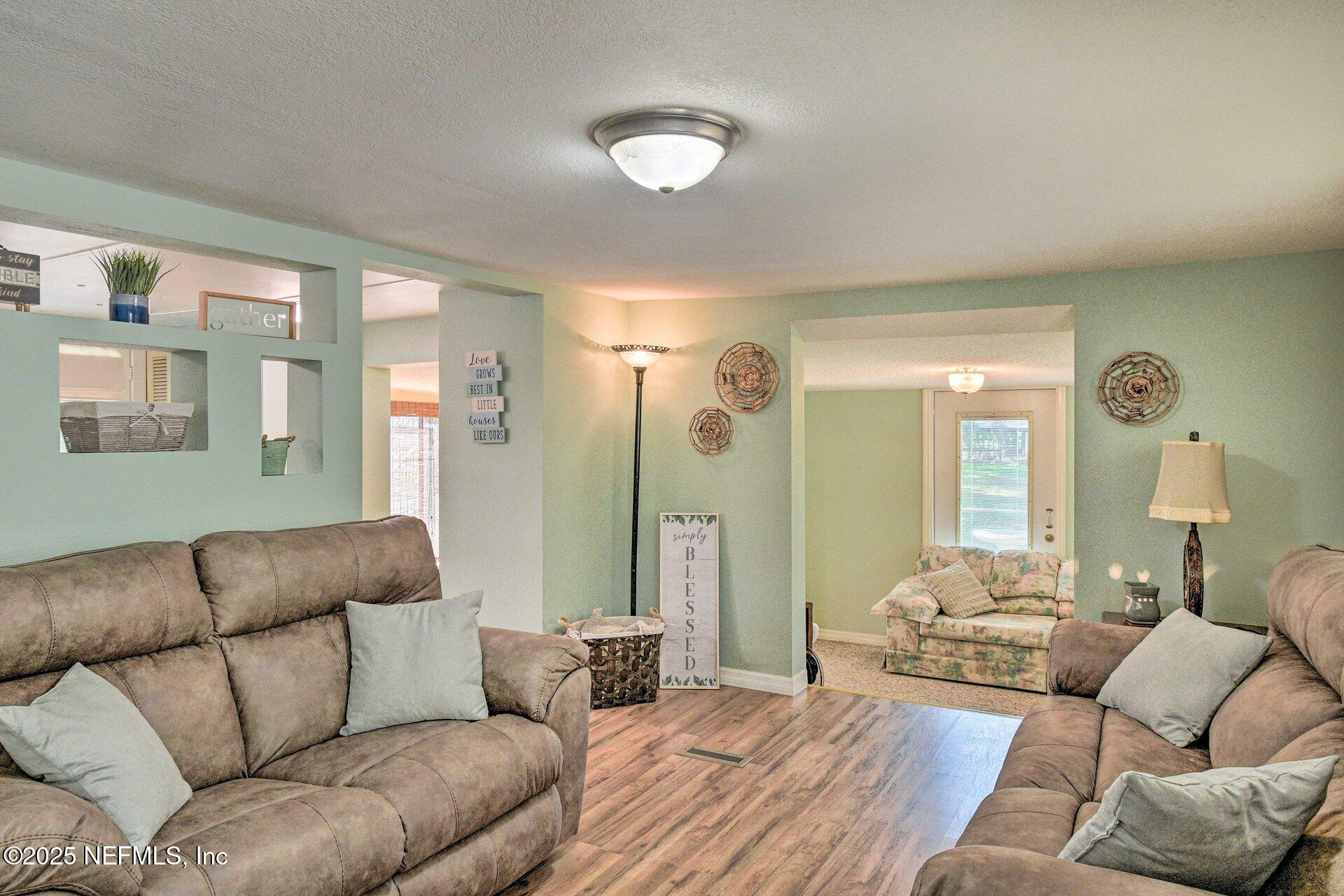 118 Riverside Avenue Satsuma, FL 32189 - Photo 4 of 27 a living room with furniture and a large window