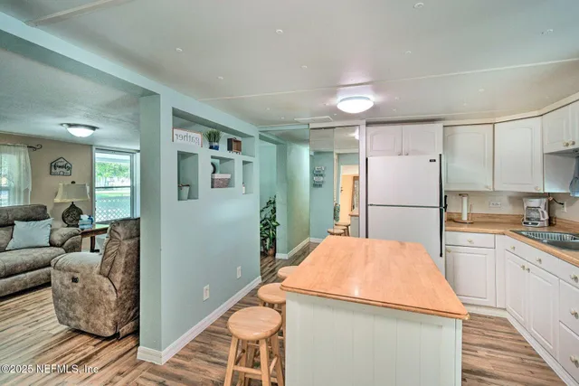 a kitchen with stainless steel appliances a refrigerator sink and wooden cabinets