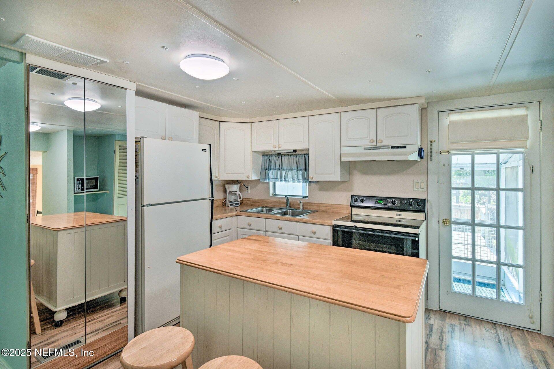 118 Riverside Avenue Satsuma, FL 32189 - Photo 7 of 27 a kitchen with a refrigerator sink and stove
