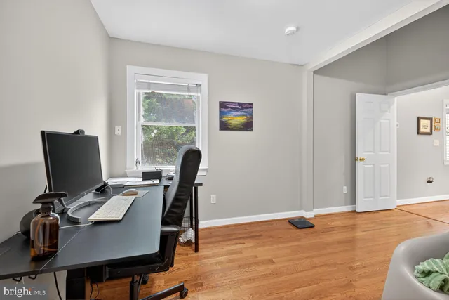 a view of a workspace with furniture and a window