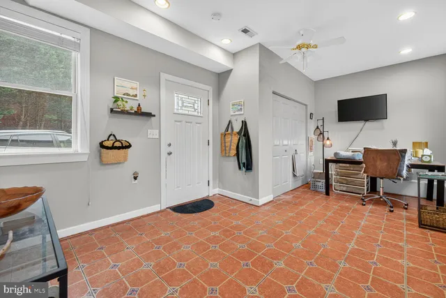 a view of a livingroom with workspace and a window