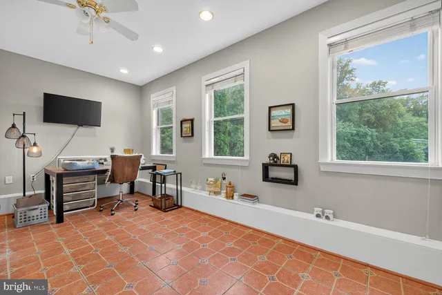 a room with furniture a flat screen tv and a window