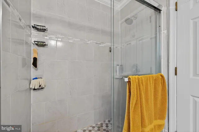 a bathroom with a shower and a bath tub