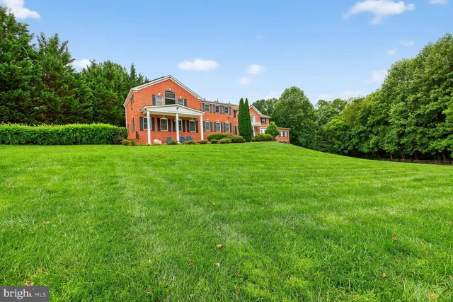 a house with green field in front of it