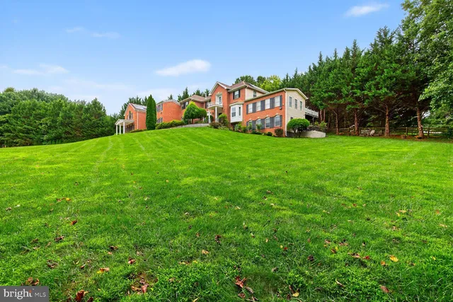 a view of a play ground in front of a house with a yard