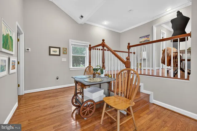 a view of a room with wooden floor and windows