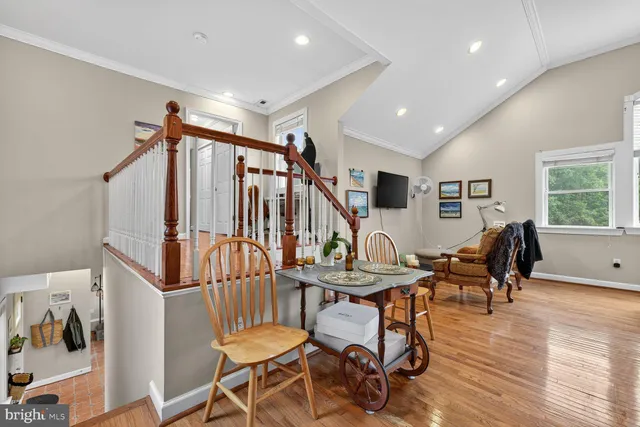 a livingroom and dining room with wooden floor windows