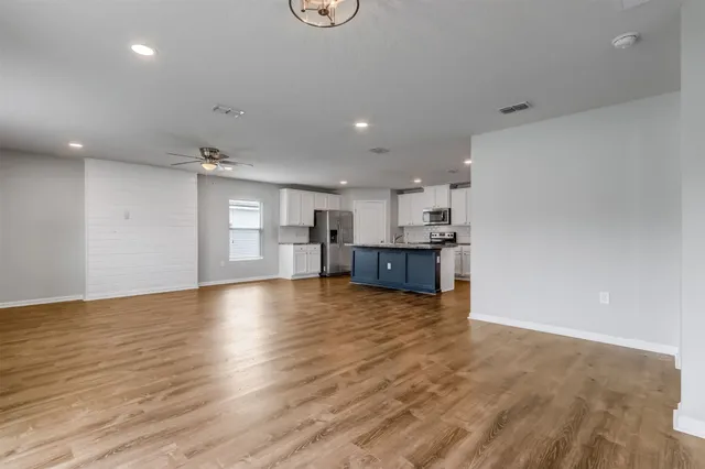 a view of kitchen and kitchen with a sink oven cabinets