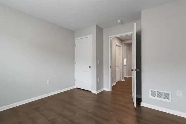 wooden floor in a hall with an empty room