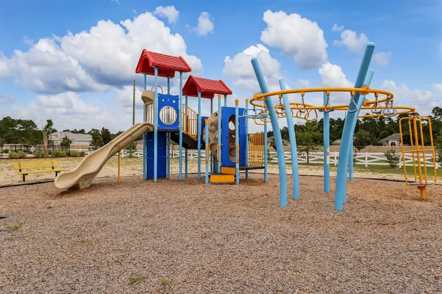 a play ground with the view of the house