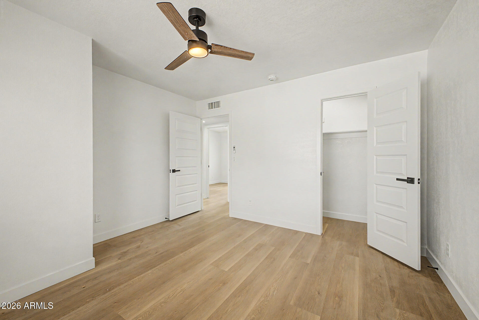 7214 West Flower Street Phoenix, AZ 85033 - Photo 14 of 29 a view of empty room with wooden floor