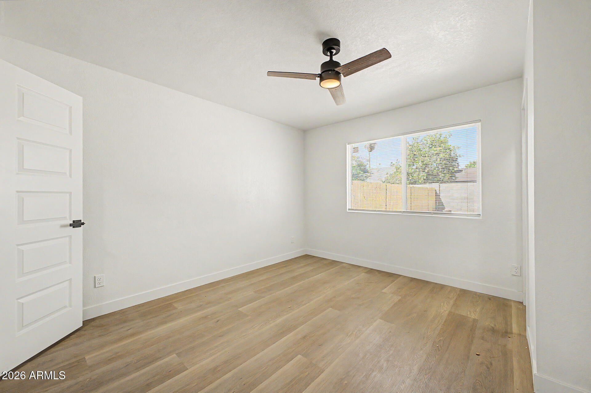 7214 West Flower Street Phoenix, AZ 85033 - Photo 19 of 29 wooden floor in an empty room