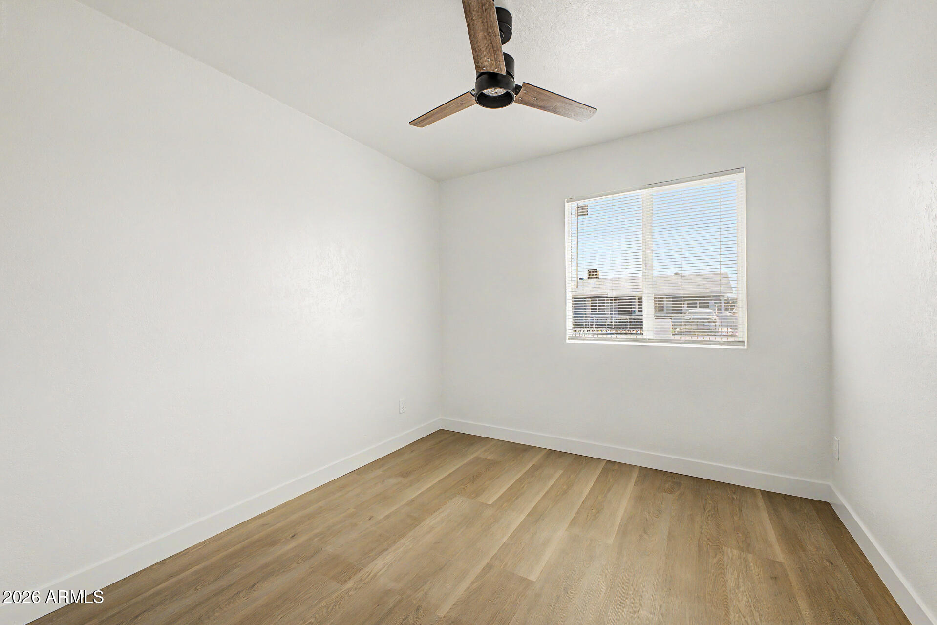 7214 West Flower Street Phoenix, AZ 85033 - Photo 20 of 29 a view of an empty room with a window
