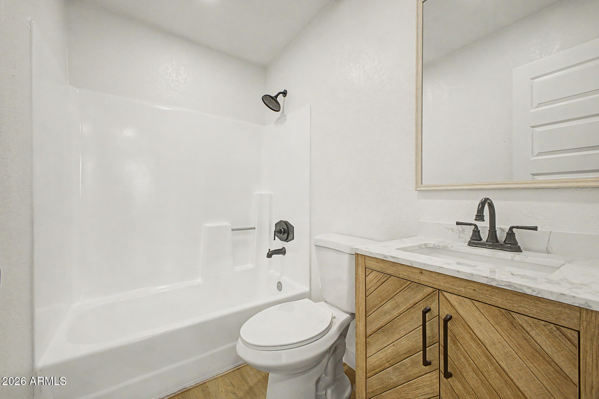 7214 West Flower Street Phoenix, AZ 85033 - Photo 22 of 29 a bathroom with a granite countertop sink toilet and shower