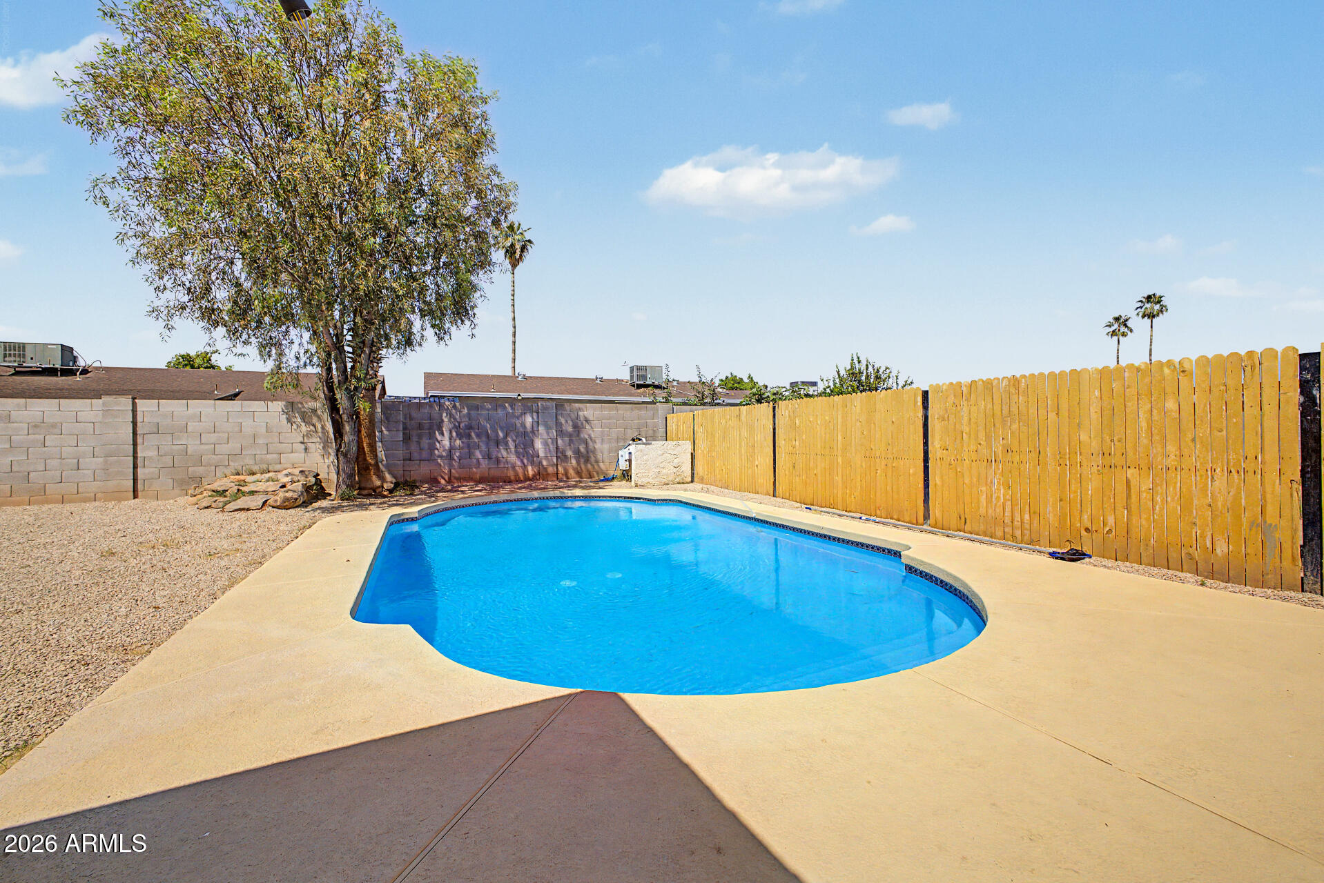 7214 West Flower Street Phoenix, AZ 85033 - Photo 25 of 29 a view of a swimming pool and a yard