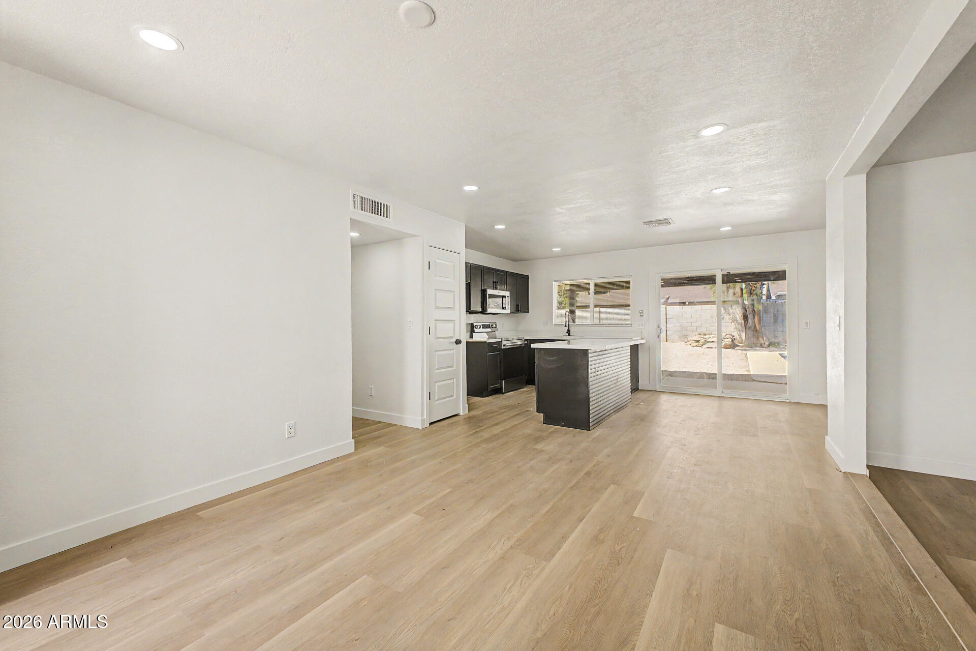 7214 West Flower Street Phoenix, AZ 85033 - Photo 7 of 29 a view of a kitchen with refrigerator and a stove top oven