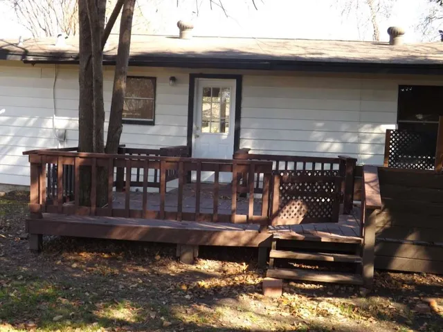 a view of a house with wooden deck