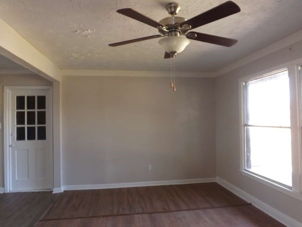 822 Harvard Street Deer Park, TX 77536 - Photo 6 of 16 an empty room with windows and fan