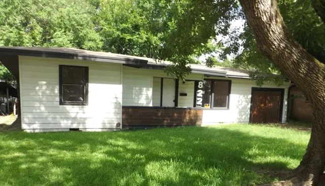 a view of house with backyard space and garden