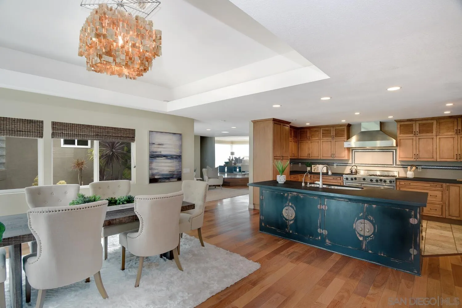 5459 Moonlight Lane La Jolla, CA 92037 - Photo 16 of 42 a living room with furniture a wooden floor and a kitchen view