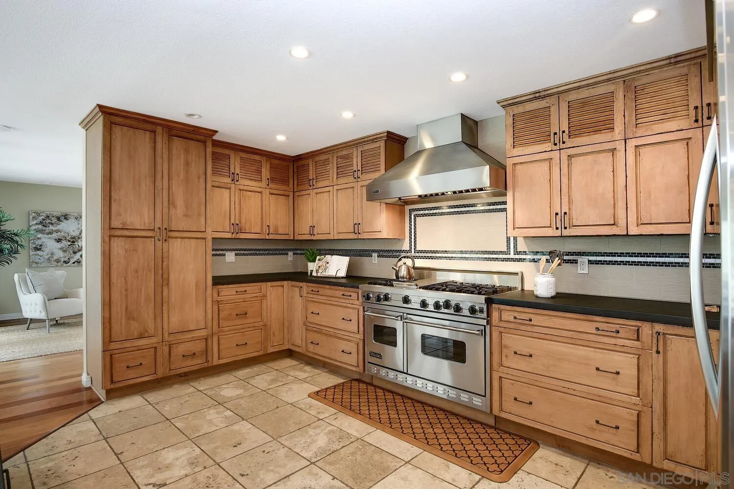5459 Moonlight Lane La Jolla, CA 92037 - Photo 18 of 42 a kitchen with kitchen island granite countertop cabinets and steel stainless steel appliances