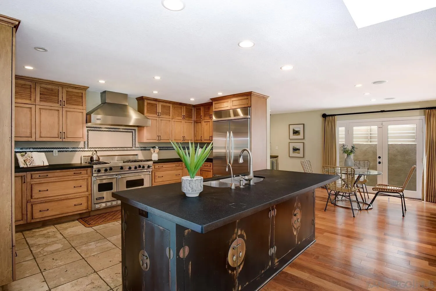 5459 Moonlight Lane La Jolla, CA 92037 - Photo 20 of 42 a kitchen with stainless steel appliances granite countertop a sink a stove and a refrigerator