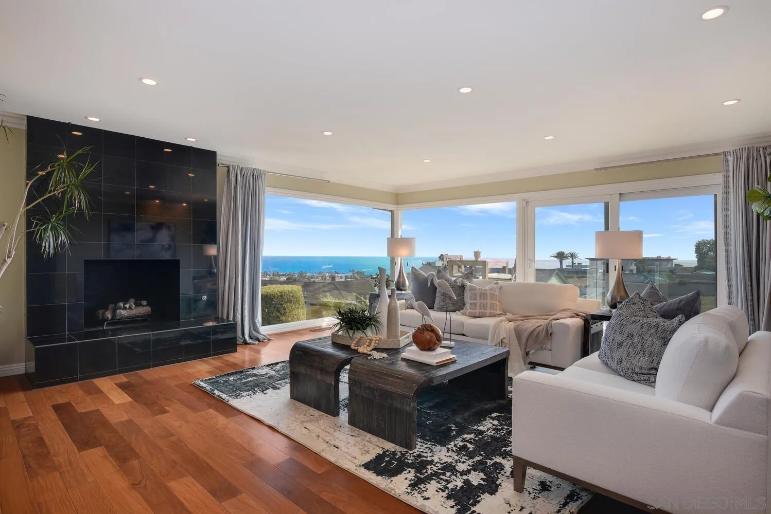 5459 Moonlight Lane La Jolla, CA 92037 - Photo 21 of 42 a living room with furniture large window and a fireplace